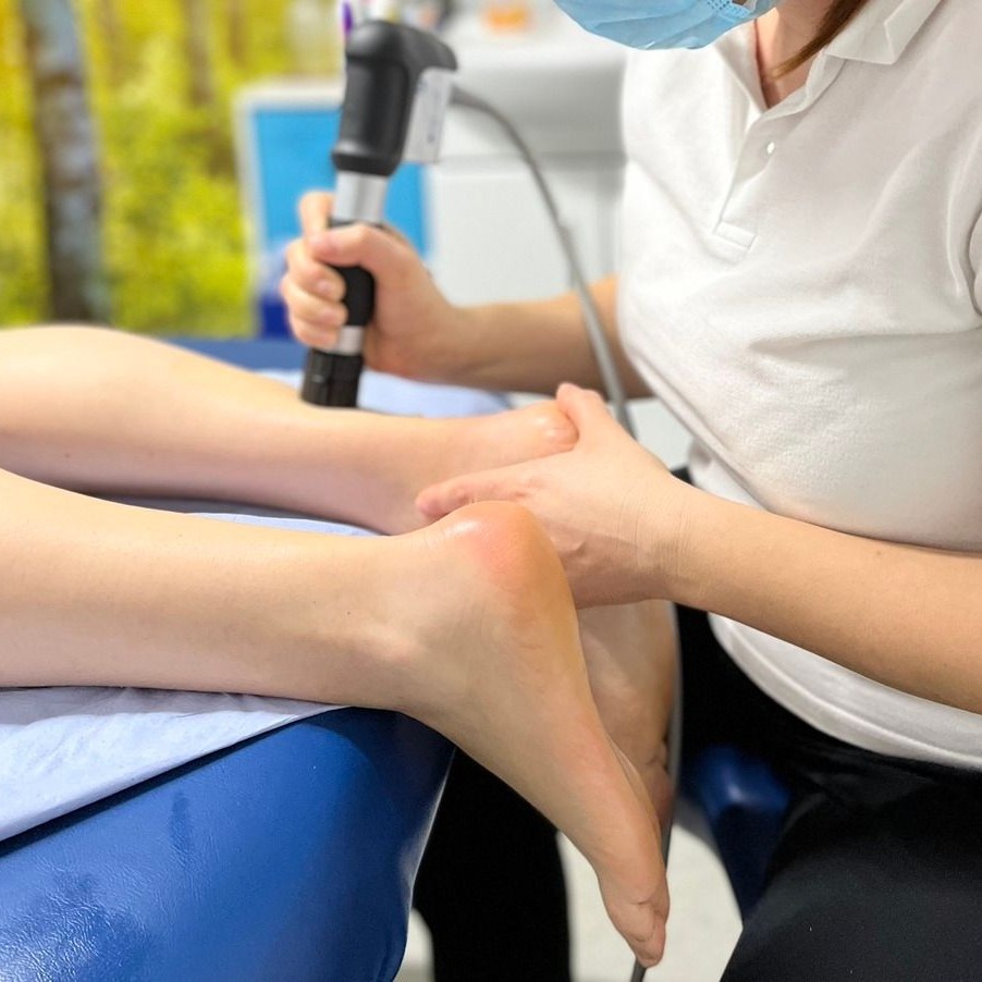 Image of shockwave therapy on legs with link towards the main U Go Physio clinic website