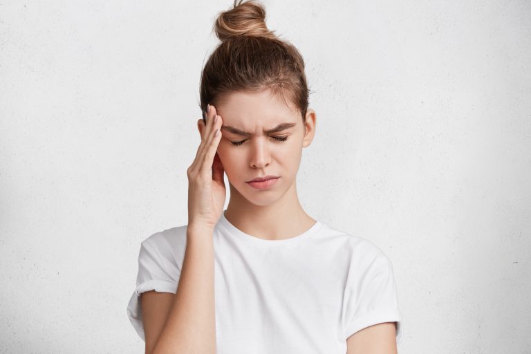 Woman showing Headache and migraines